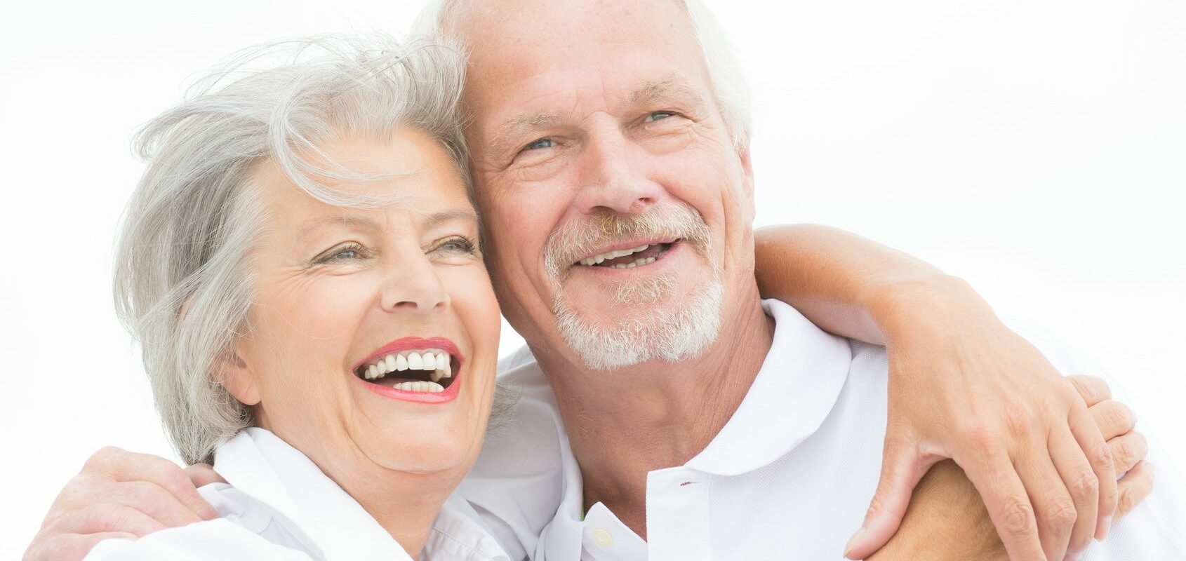 Happy senior couple Happy and smiling couple in front of white sky